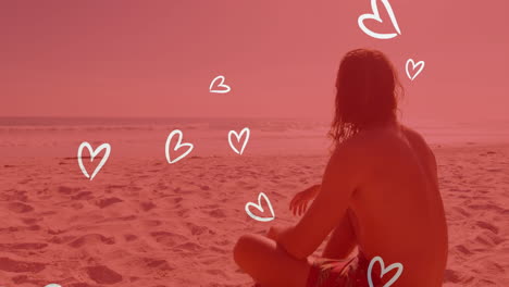 sitting on beach, person with heart animation overlay on red-tinted scene