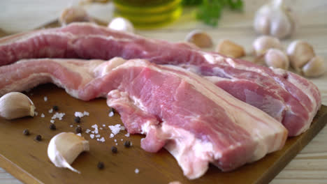 fresh raw streaky pork on wood board with ingredient