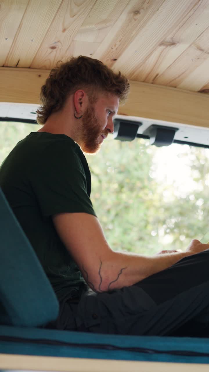 Man Reading in a Van