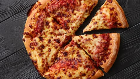 fluffy pepperoni pizza in american style placed on rusty old black wooden table