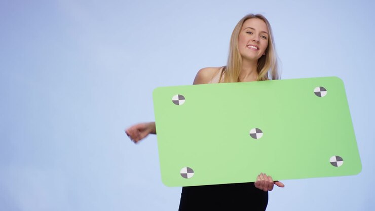 Very attractive Woman holding oversized blank Card and pointing on it