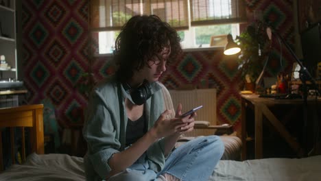 teenage girl using phone in her bedroom