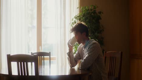 man drinking coffee at home