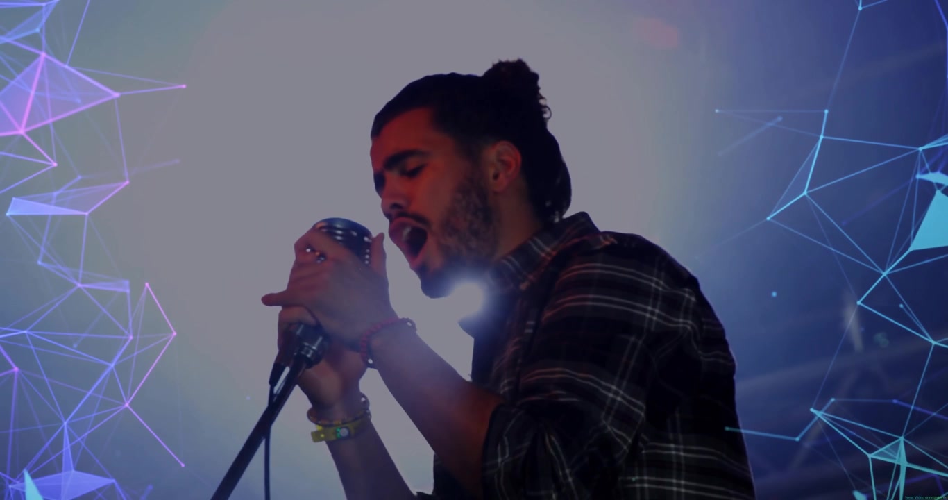 Singer leaning into mic and performing music with lamp flare obscuring shadow with purple polygons