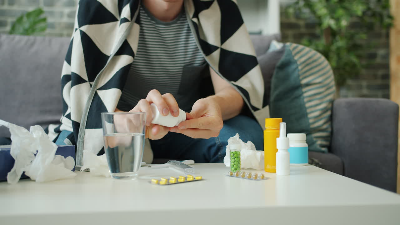Man Taking Medication for Illness at Home
