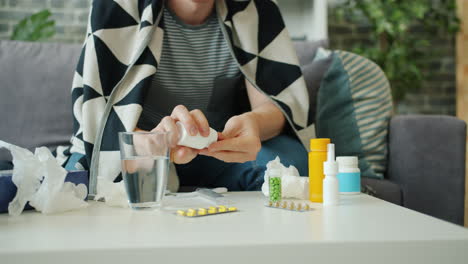 man taking medication for illness at home