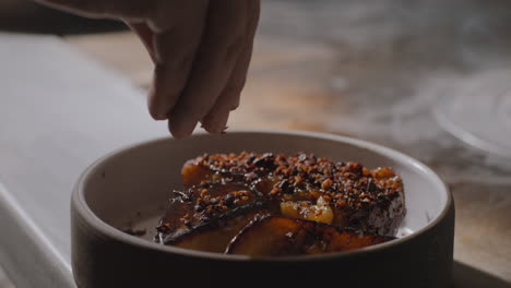 garnishing a plate of sauteed sweet potatoes