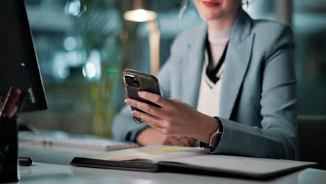 woman using phone at desk