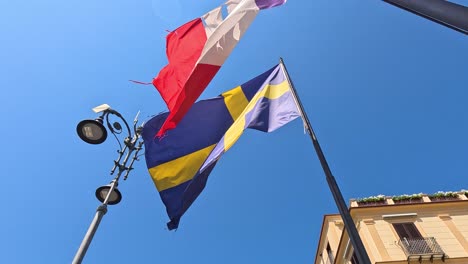 flags fluttering in the wind in sorrento