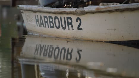 docked small emergency row boat with harbour number 2 printed on side