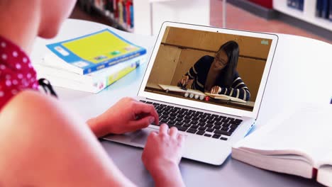 Caucasian-female-teacher-using-laptop-on-video-call-with-female-student