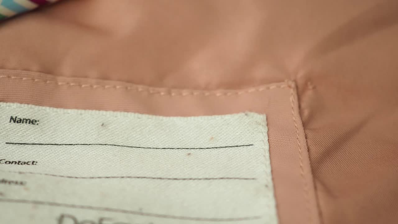 Close-up of a name and contact label on clothing