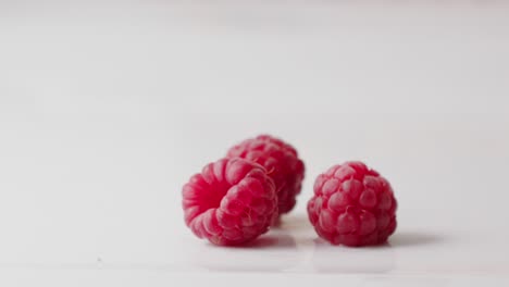 red wet raspberries falling down