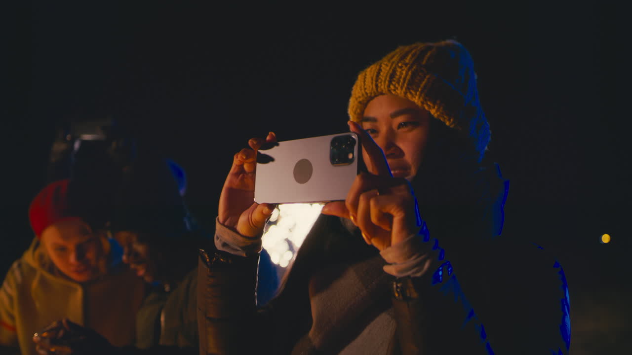 People celebrating with fireworks at night