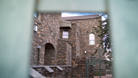 old castle or mansion with brick and stone and metal fence