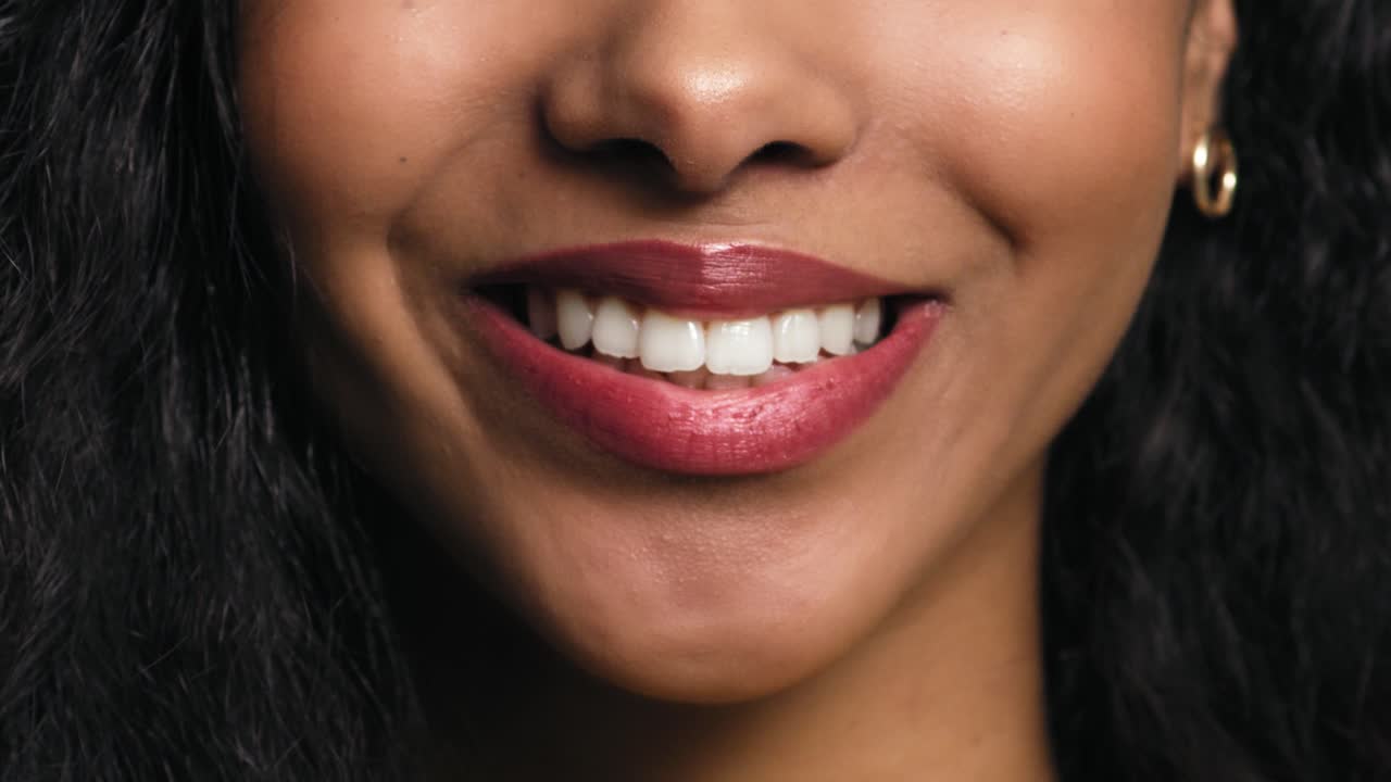 Close up video of a smiling part the face of young woman