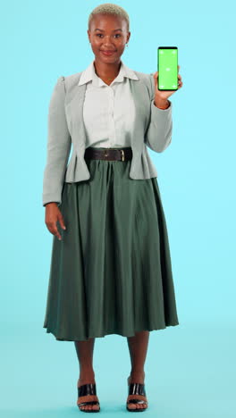 businesswoman holding smartphone with green screen
