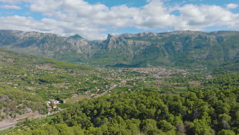 aerial view of a picturesque village nestled in a valley, surrounded by mountains