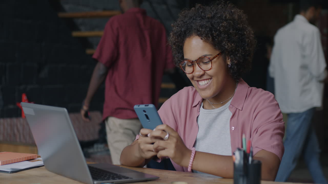 Woman using smartphone at her workplace