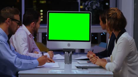 businesspeople looking at computer