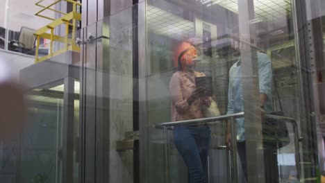 video of diverse businesswoman and businessman talking in elevator