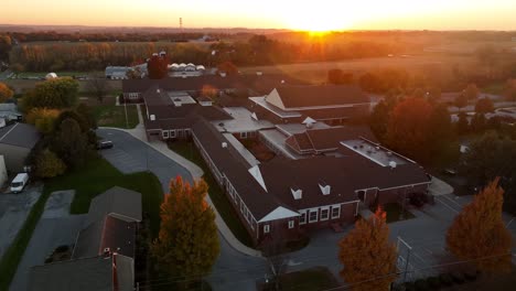 Aerial-orbit-of-red-brick-school-building-in-USA