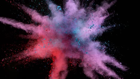 super slow motion of colored powder explosion isolated on dark background.