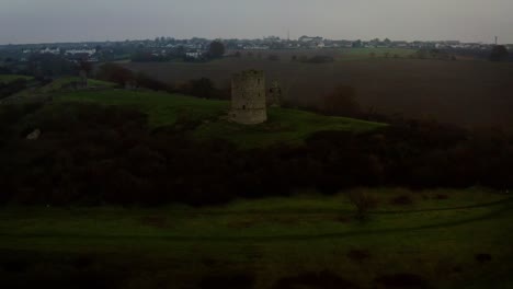aerial view of an ancient stone tower ruin on a hilltop