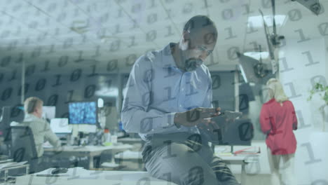 animation of binary coding over african american businessman using smartphone