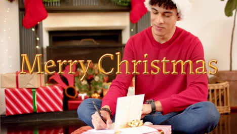 animation of happy holidays text over caucasian man writing christmas cards with presents