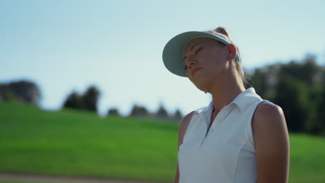 sexy golf player stretching at course. beautiful woman doing sport in summer.