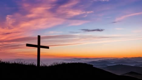 cross on a hilltop at sunset