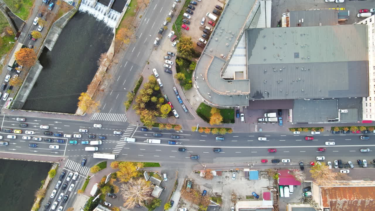 Streetscape of Bucharest, lakes in a park and crossroads near the water channel with lots of moving cars. View from the drone, Romania