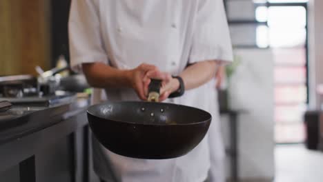 Caucasian-female-chef-teaching-diverse-group-preparing-dishes-and-smiling