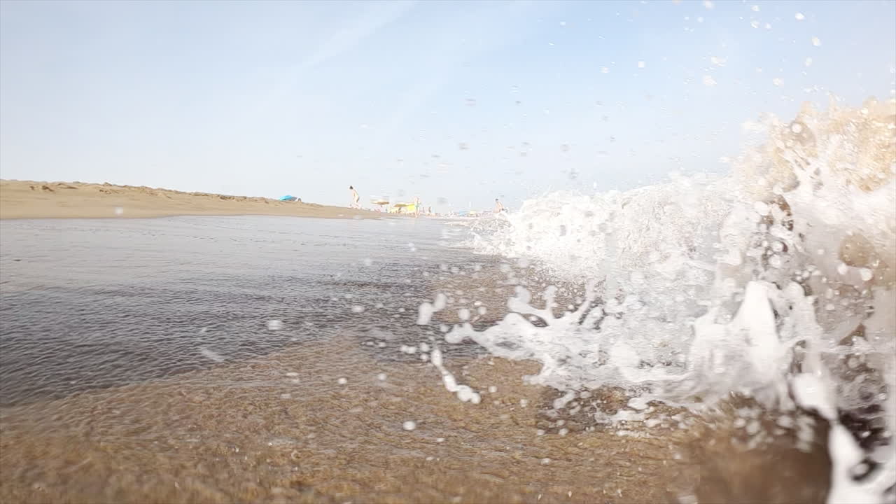 Waves hitting the shore on the beach