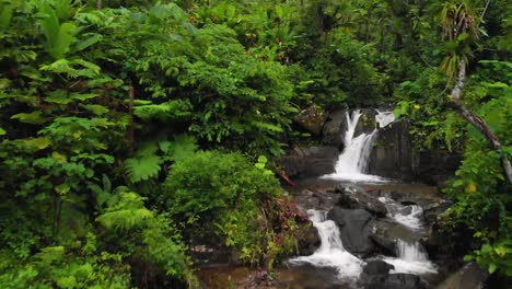 drone shot pushing into a waterfall