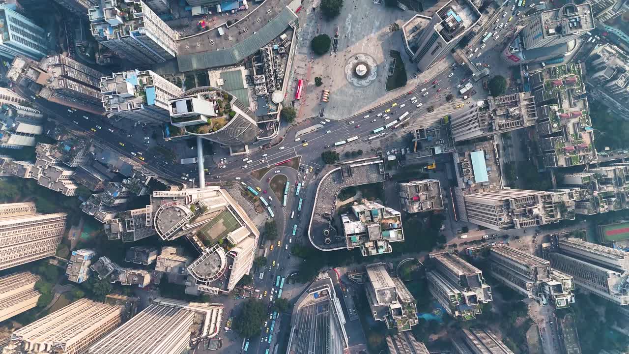 Aerial view of busy traffic in Chongqing, China, with multiple roads intersecting at a central point. A snapshot of the city’s bustling urban environment and complex infrastructure.