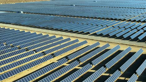 aerial rising over solar panel field in mojave, ca cell, renewable concept