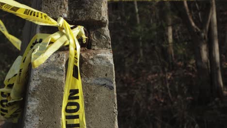 concrete barricade with caution tape blowing in wind