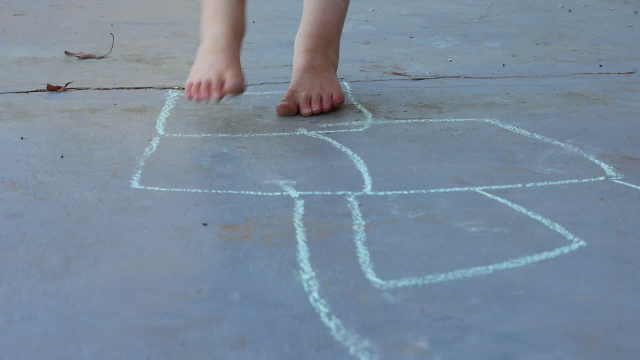Child Playing Hopscotch Outdoors