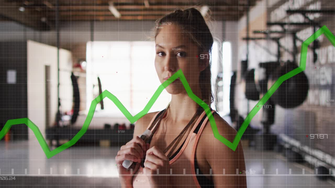 Woman holding jump rope in gym camera zooming green graph HUD animating passing face showing data