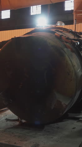 large industrial tank in a dark warehouse
