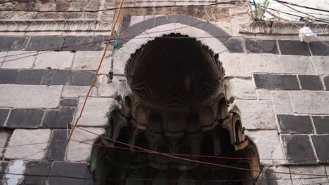 panning-shot-of-black-and-white-arab-archway-to-a-mosque-in-Tripoli,-Northern-Lebanon