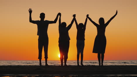 friendly multi-generational family together raise their hands up