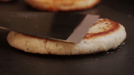 cooking american fat smash burger on grill close-up. chiken or fish cutlet smashing by burger press. the chef in kitchen of the restaurant making cutlets for burgers - smash burger beefsteak. fast and street food concept. high quality 4k footage