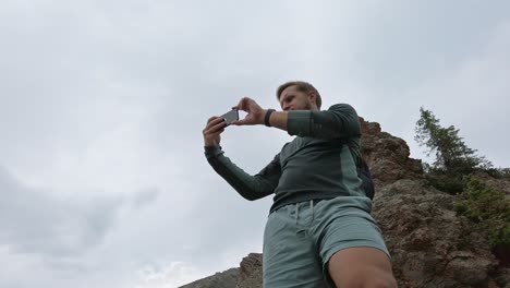 hiker taking photos low angle rockies kananaskis alberta canada