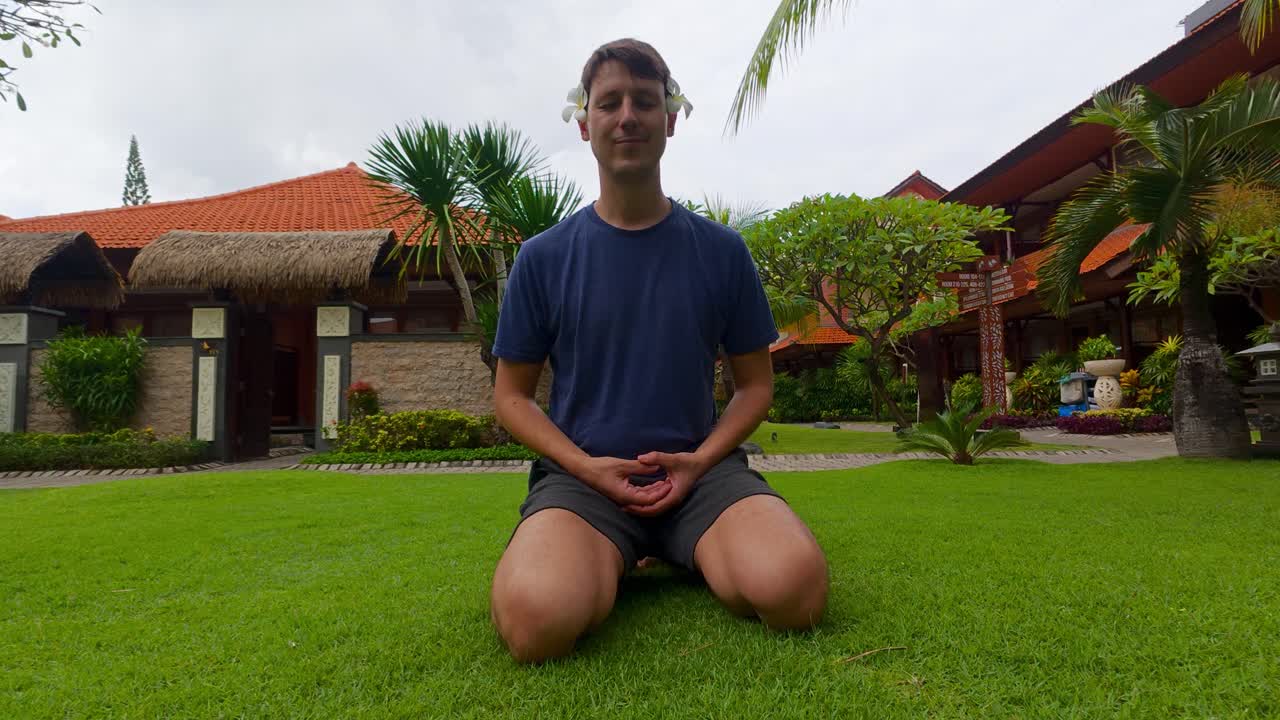 Man Meditating in a Tropical Garden