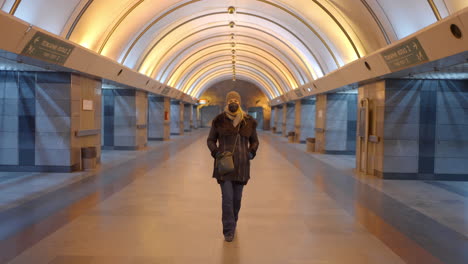 woman in mask in subway station