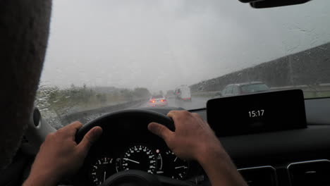 driver navigating rainy road with windshield wipers