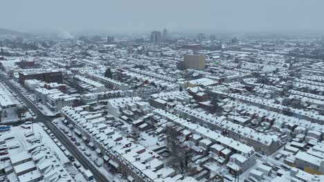 aerial flyover snow covered town in america in winter